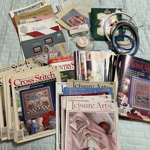 Cross Stitch magazines, pattern books, hoops, and fabric.